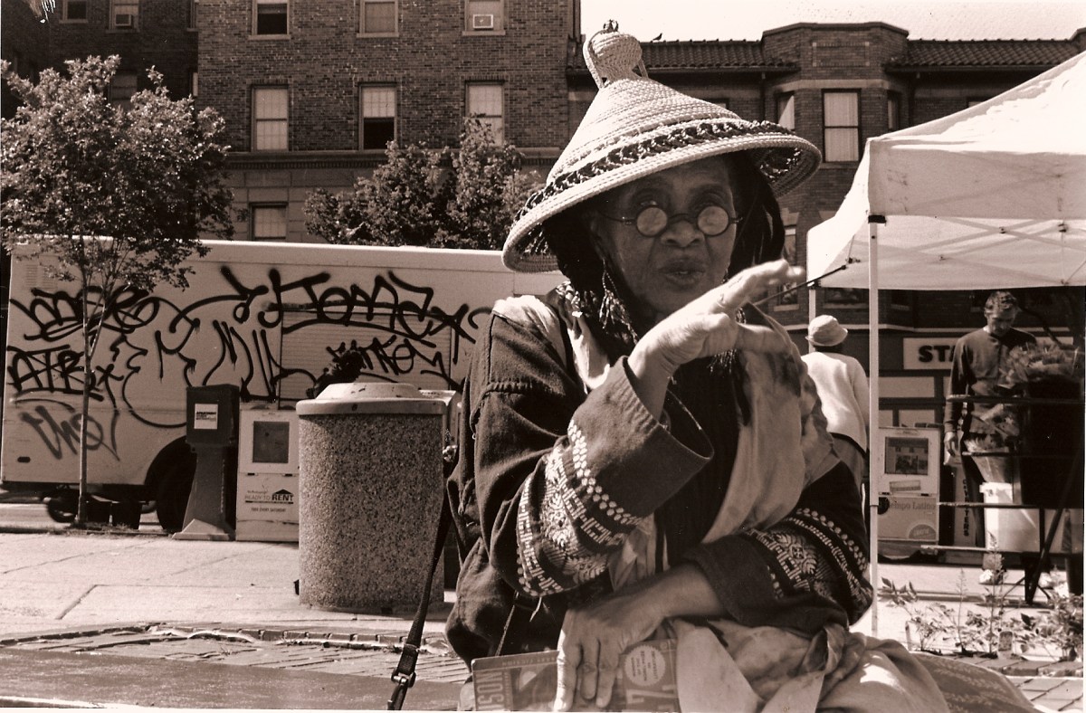 Photo of a lady wearing a cone-shaped African hat