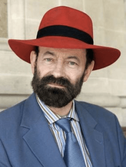 photo of Raymond Tallis wearing a red hat